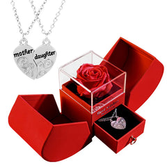 Red jewelry box with a red rose and two necklaces for mother and daughter