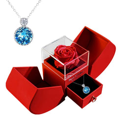 Red jewelry box with a red rose and blue gemstone necklace  