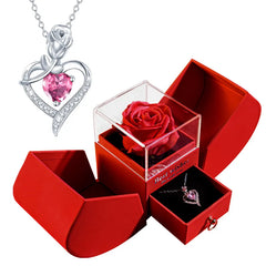Silver heart-shaped necklace with pink gem and red rose in a red box 